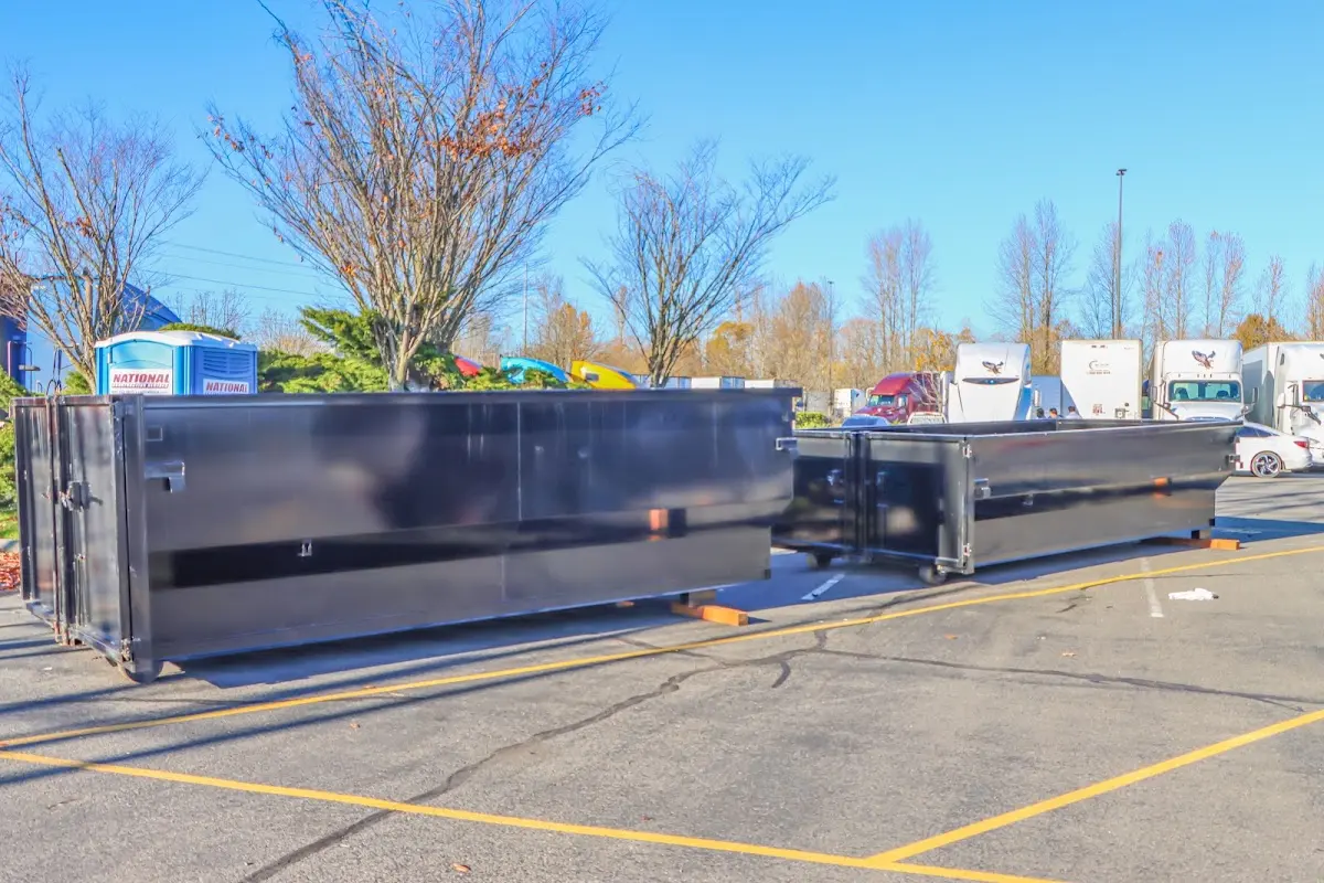 Professional dumpster rental service with roll-off container on residential driveway in Carl Junction